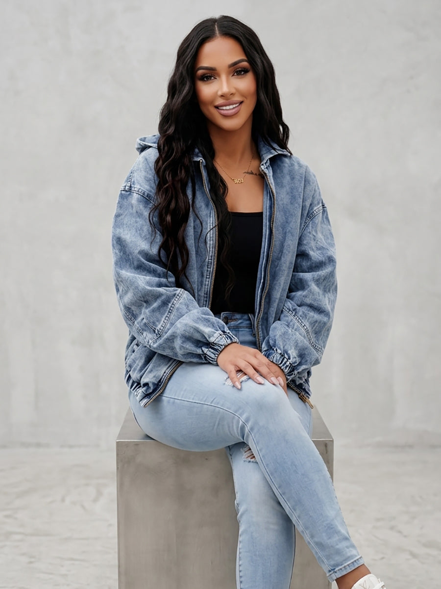 Light wash hooded denim jacket with a zip front and gathered cuffs