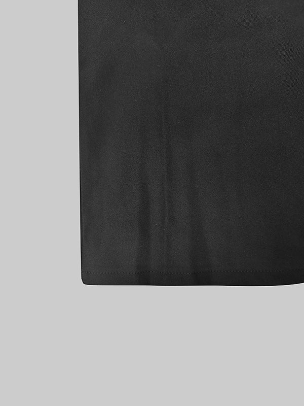 Floor-length black coat with a satin peak lapel and side splits