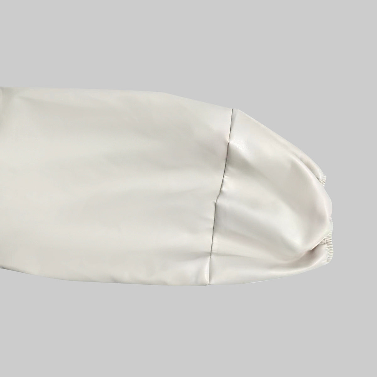 Cropped cream bomber jacket with black contrast panels and a zip front