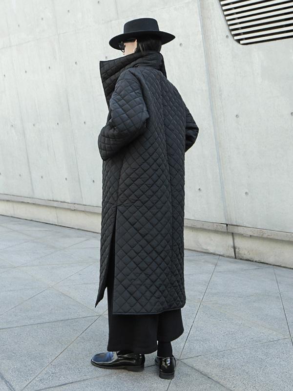 Long black quilted wrap coat with a fold-over collar and ring-buckle belt