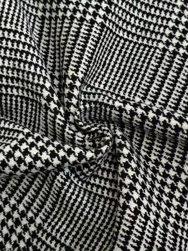 Houndstooth check jacket with an asymmetric front and fold-over collar