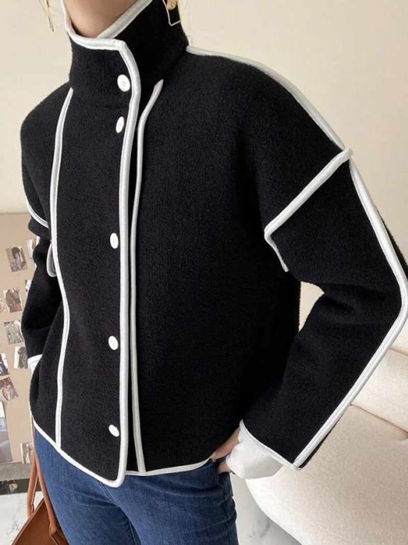 Boxy jacket with contrast piping along the seams and a stand collar