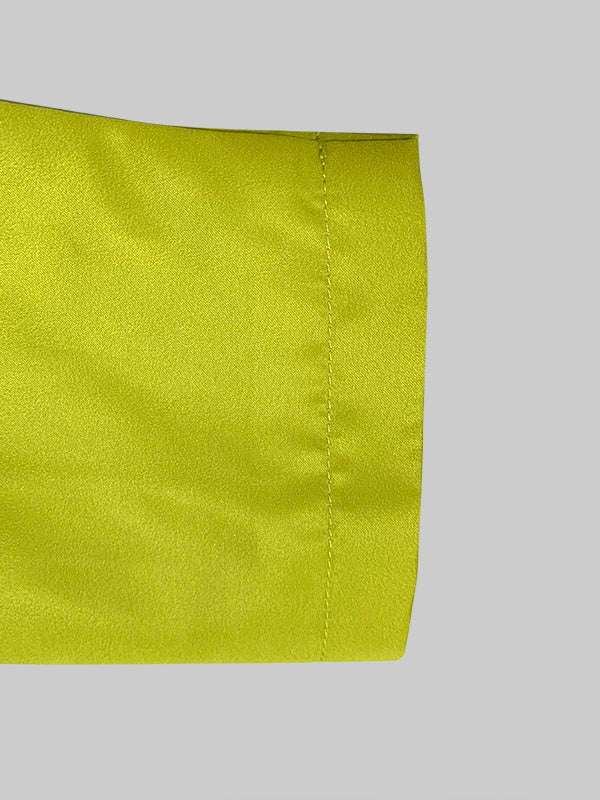 Yellow longline coat with large black polka dots and a round neck