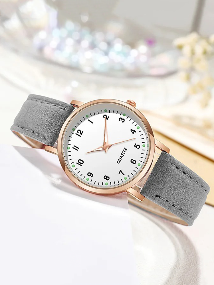 Watch with rose gold tone case and suede look strap