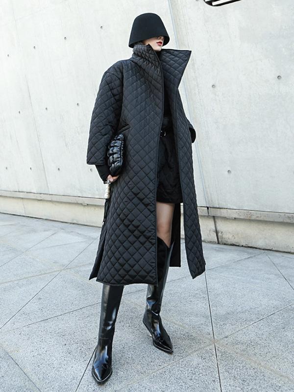Long black quilted wrap coat with a fold-over collar and ring-buckle belt
