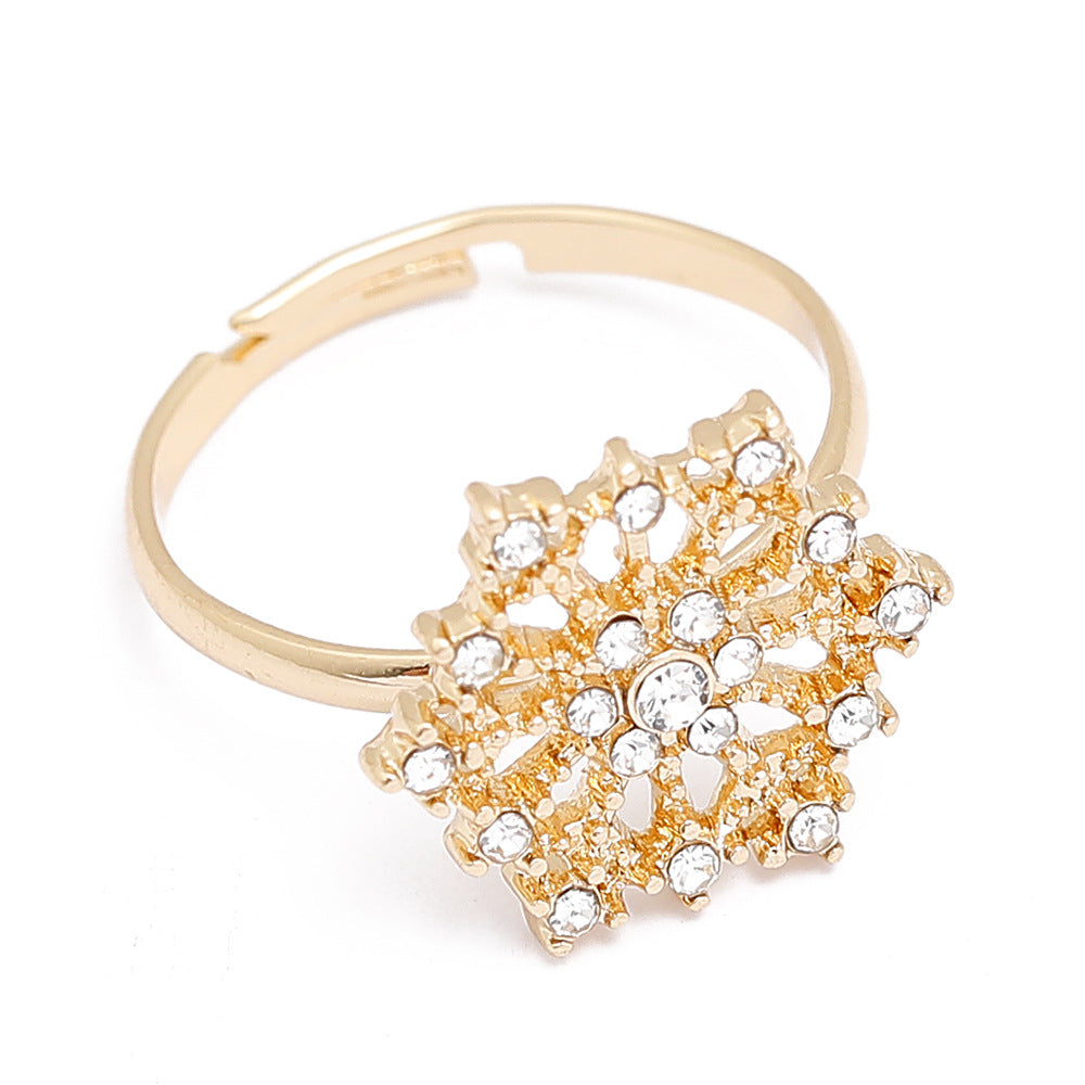 Adjustable gold-tone Christmas ring with an open band and a festive motif - snowflake with stones