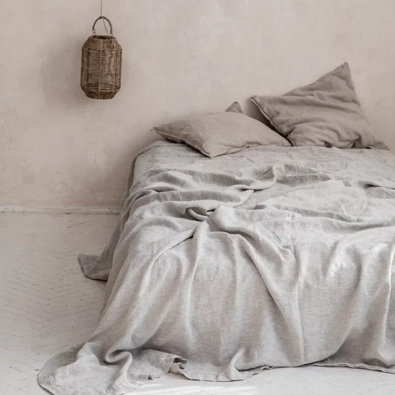 Airy woven sheet with a washed look on a bed - light grey