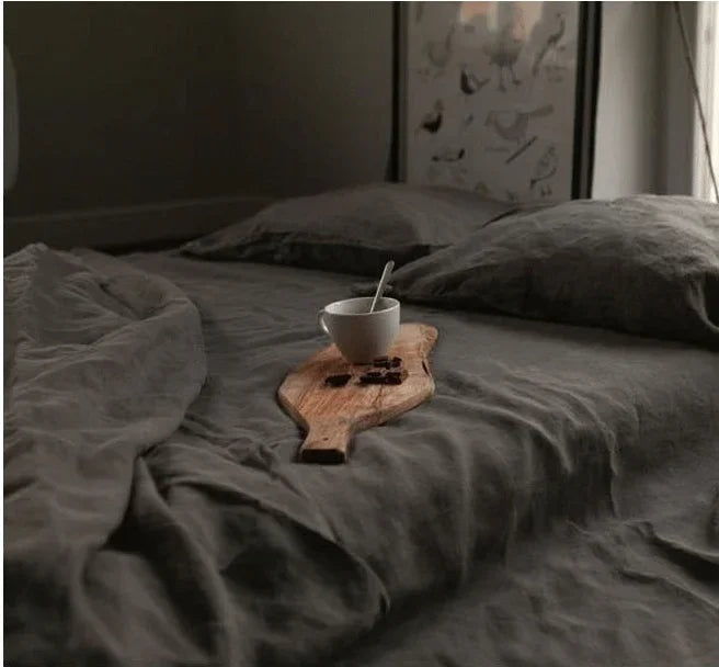 Airy woven sheet with a washed look on a bed - charcoal