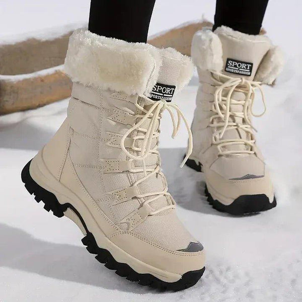 Women's lace-up snow boots with a fold-over faux fur cuff and a lug sole in beige