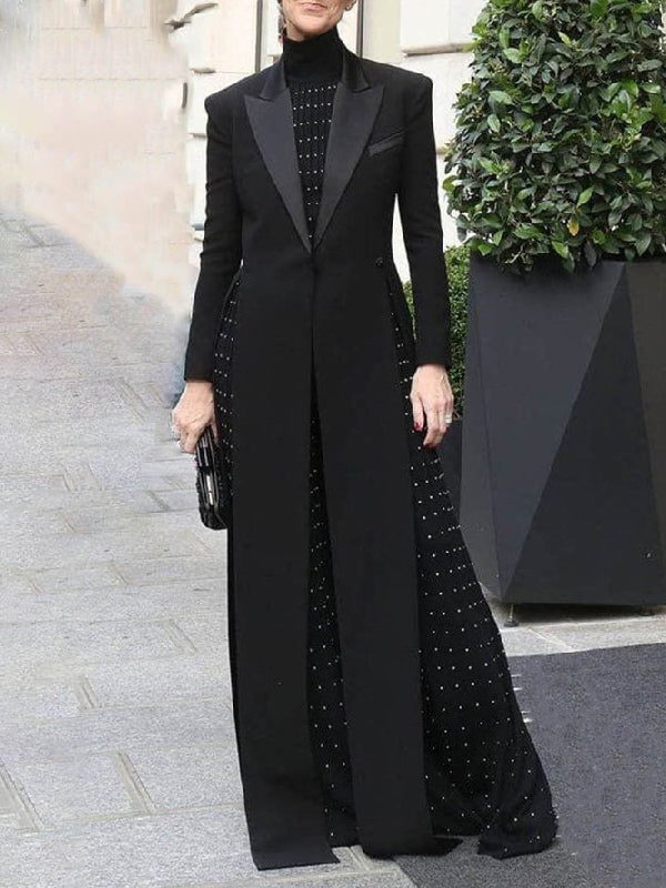 Floor-length black coat with a satin peak lapel and side splits