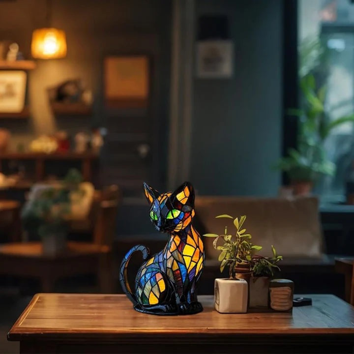 Black cat lamp in a stained glass look with green eyes and blue, orange and yellow panels