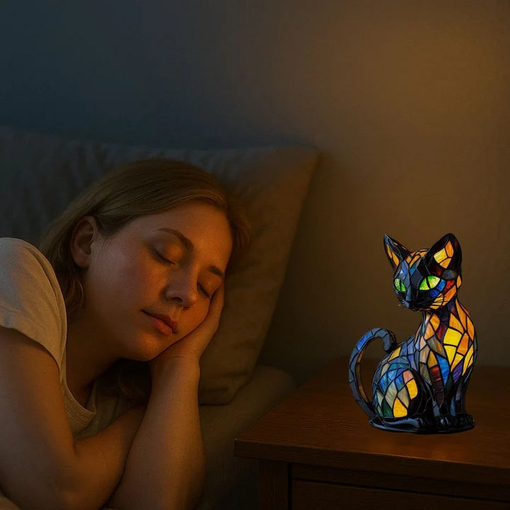 Black cat lamp in a stained glass look with green eyes and blue, orange and yellow panels