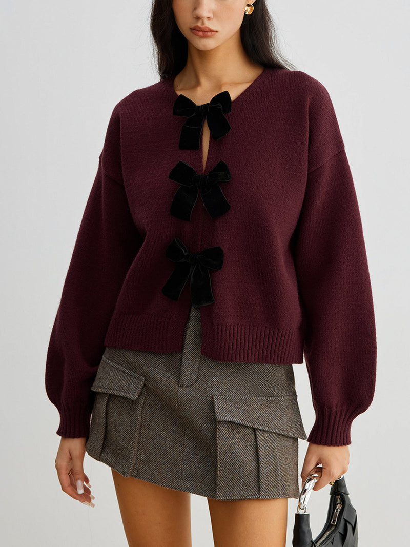 Women's short cardigan with three black bows and a crew neck