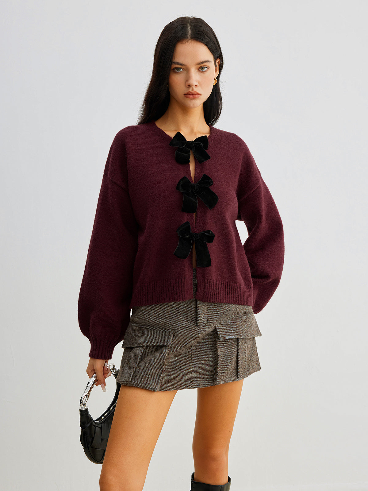 Women's short cardigan with three black bows and a crew neck