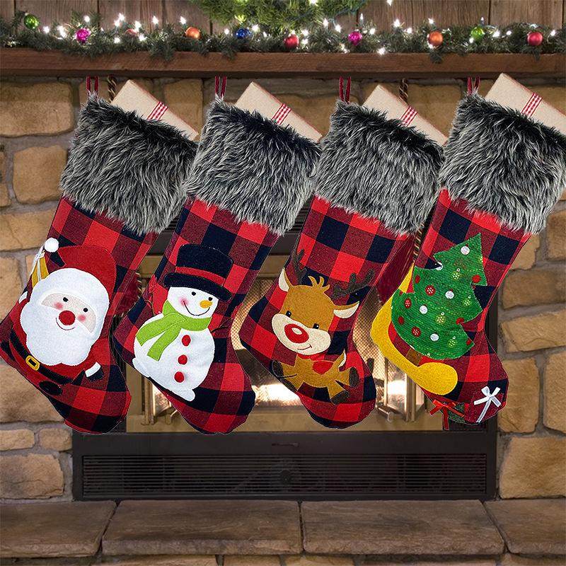 Red and black buffalo check Christmas stocking with a grey faux fur cuff