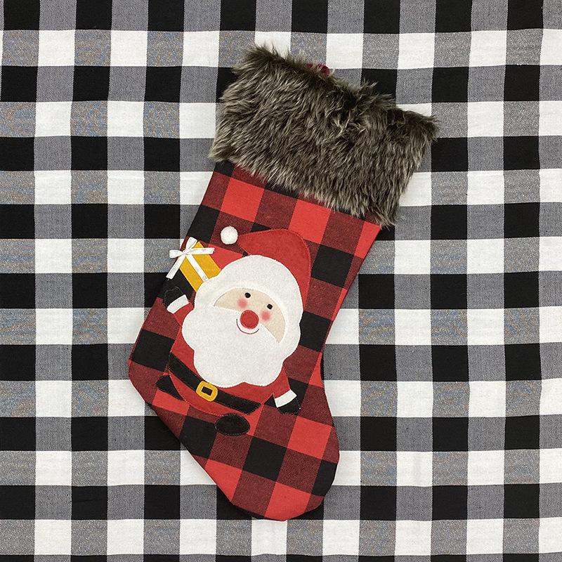 Red and black buffalo check Christmas stocking with a grey faux fur cuff - father christmas