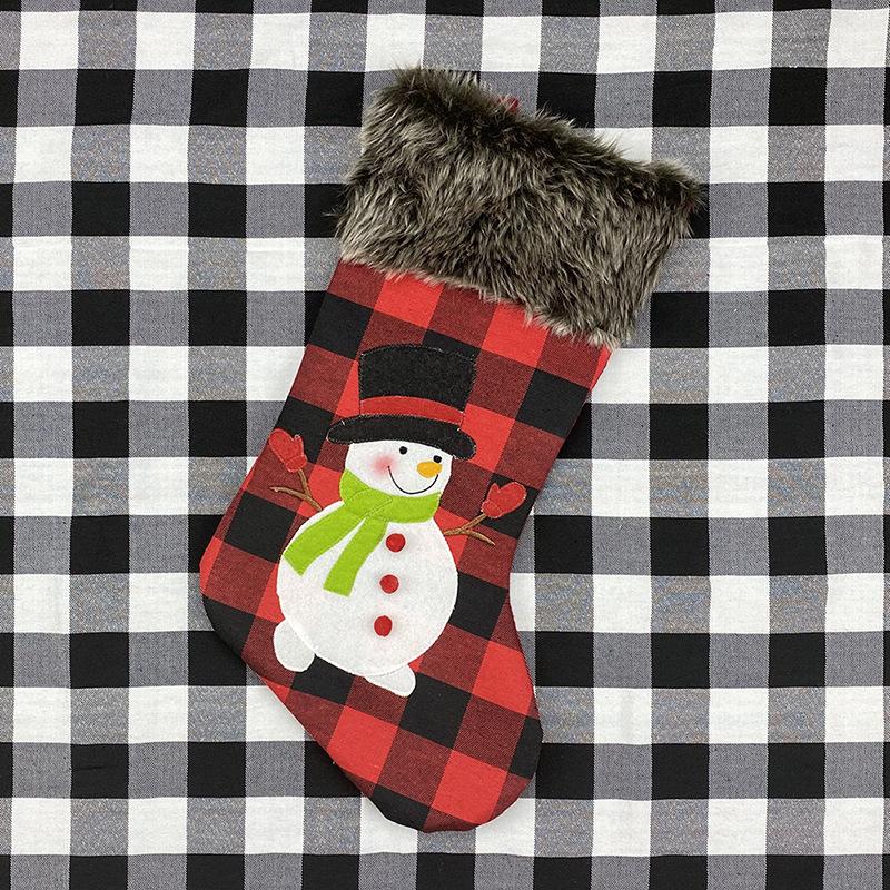 Red and black buffalo check Christmas stocking with a grey faux fur cuff - snowman
