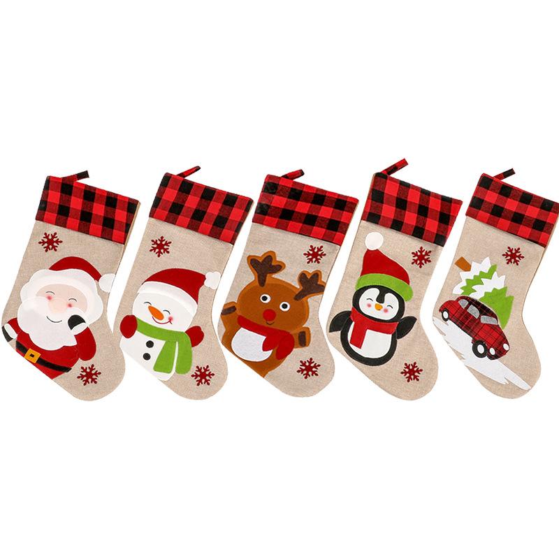 Burlap-look Christmas stocking with a red and black check cuff and a character