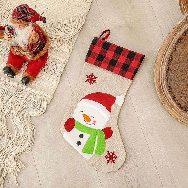 Burlap-look Christmas stocking with a red and black check cuff and a character - snowman