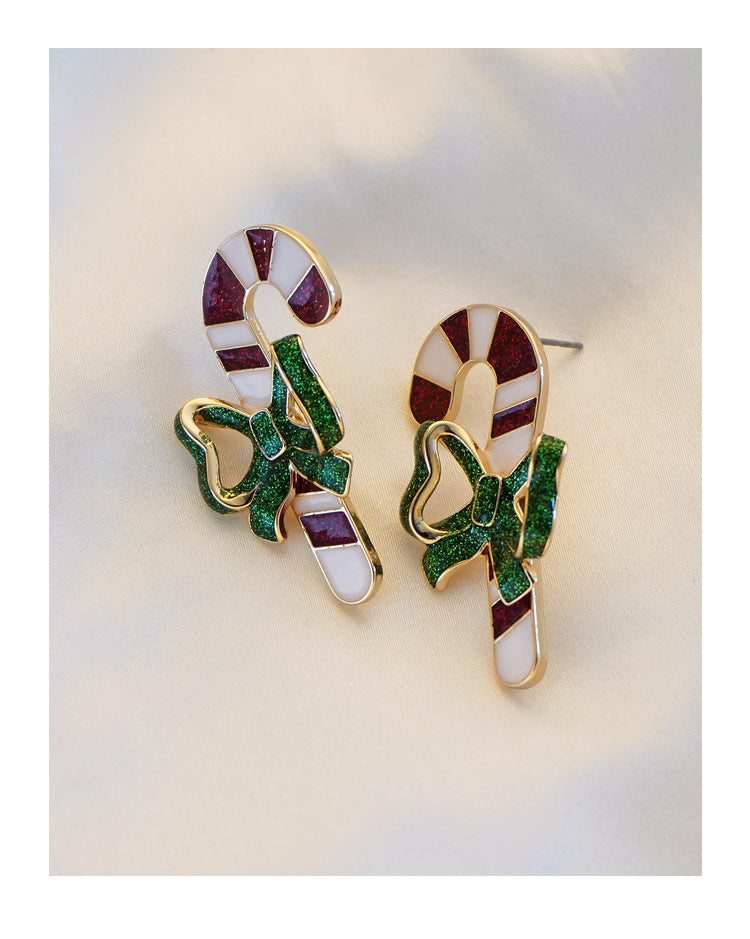 Candy cane Christmas stud earrings with a green glitter bow and gold-tone edge