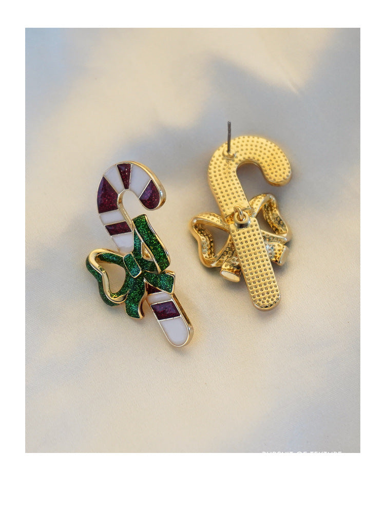 Candy cane Christmas stud earrings with a green glitter bow and gold-tone edge