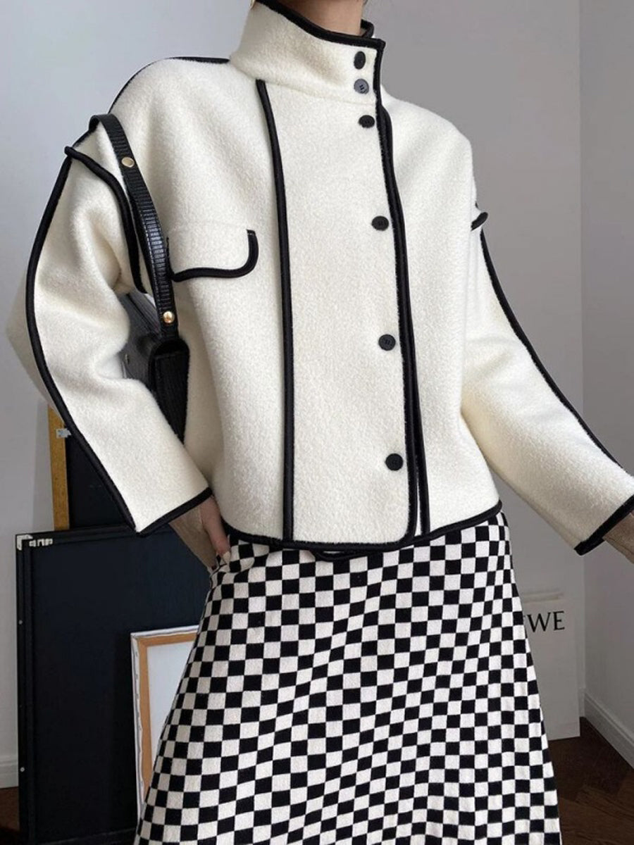 Boxy jacket with contrast piping along the seams and a stand collar
