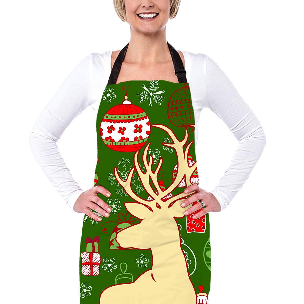 Christmas apron with a black neck strap and a festive print across the front - reindeer and bauble on green