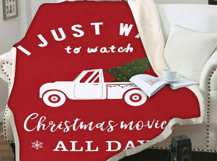 Christmas blanket with a teddy reverse and festive print, over an armchair - red pick-up movie quote