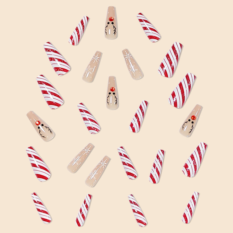 Christmas press-on nails with a festive print, applied on a hand