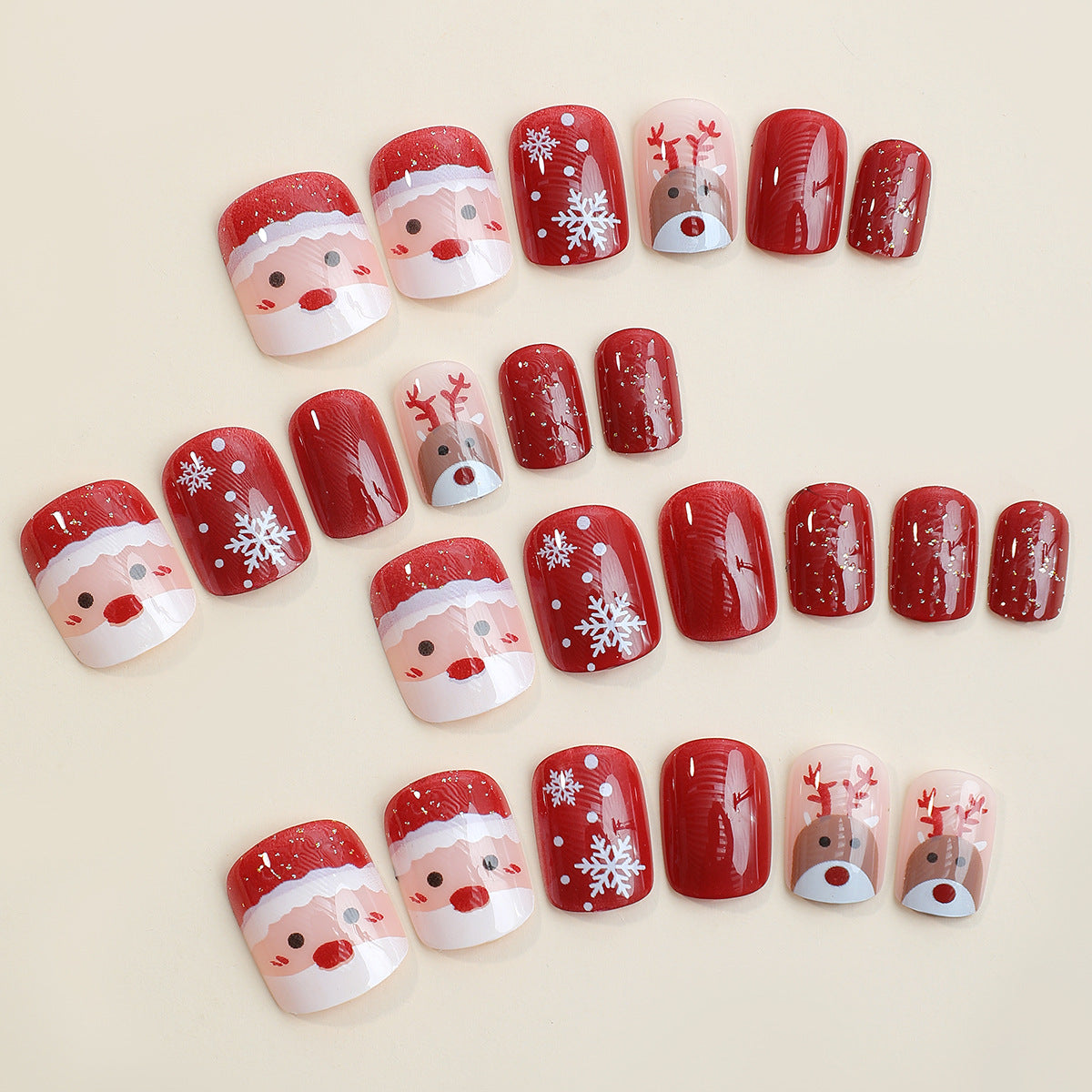 Christmas press-on nails with a festive print, applied on a hand