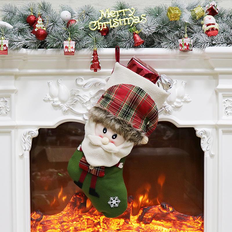 Christmas stocking with a 3D figure in a tartan hat and a white cuff by the fire