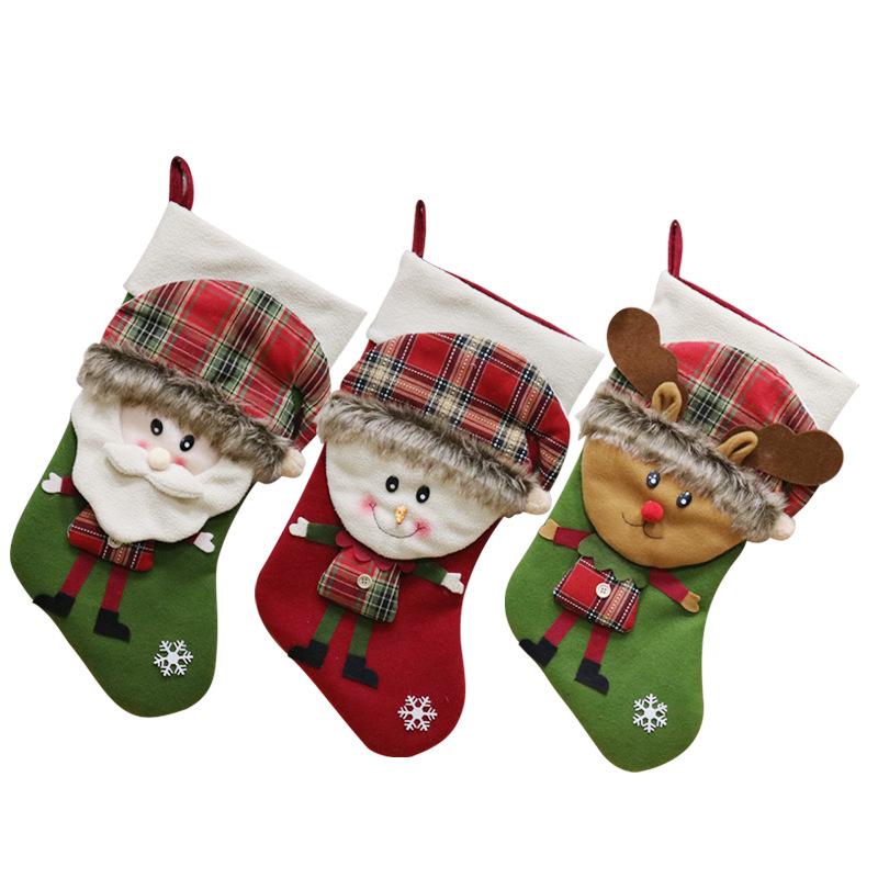 Christmas stocking with a 3D figure in a tartan hat and a white cuff by the fire
