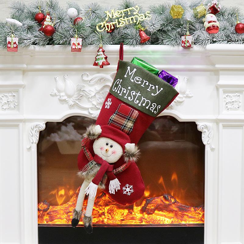 Large Christmas stocking with a dangling-leg character and Merry Christmas cuff