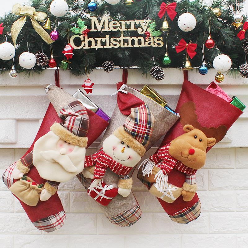 Christmas stocking with a plush figure and check toe hanging from a mantelpiece