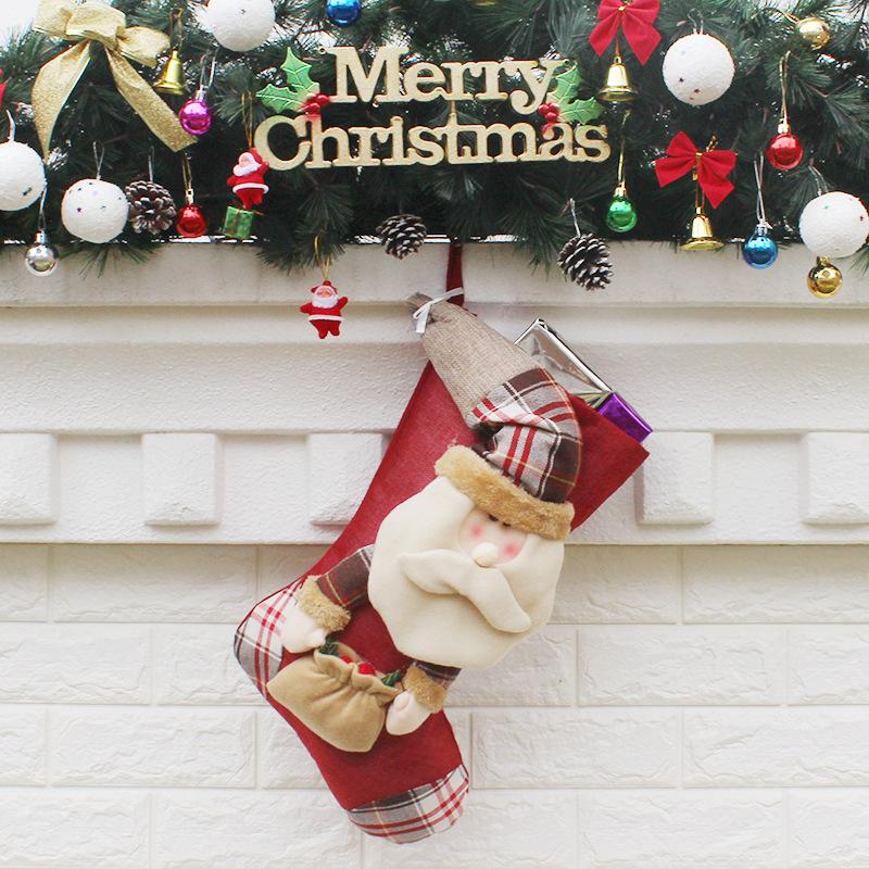 Christmas stocking with a plush figure and check toe hanging from a mantelpiece