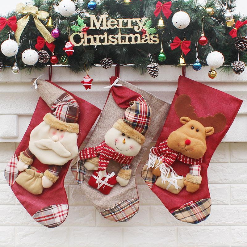 Christmas stocking with a plush figure and check toe hanging from a mantelpiece