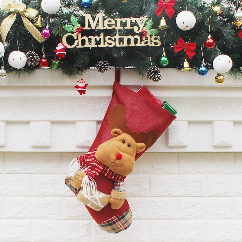 Christmas stocking with a plush figure and check toe hanging from a mantelpiece - reindeer