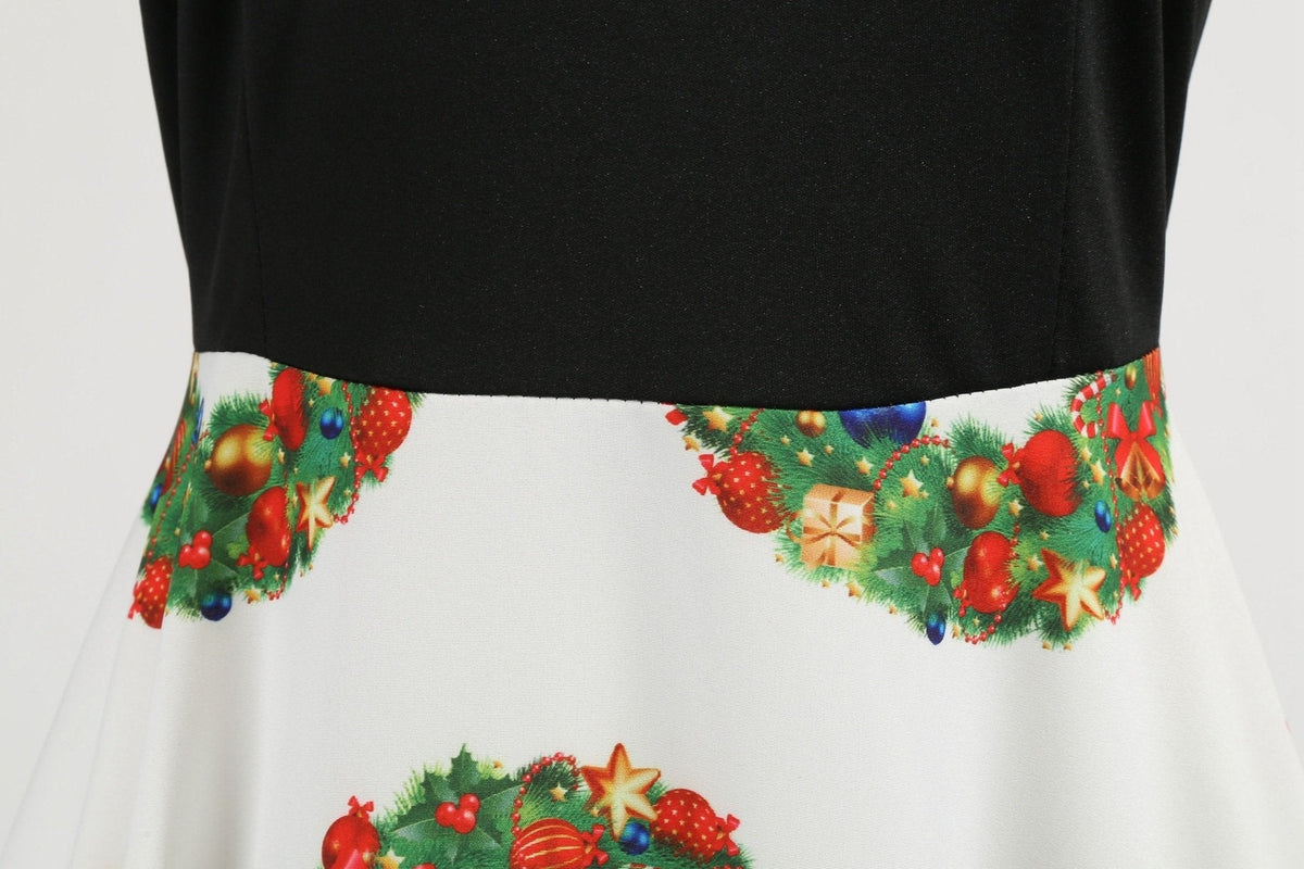 Women's Christmas swing dress with black bodice, bow belt and festive print