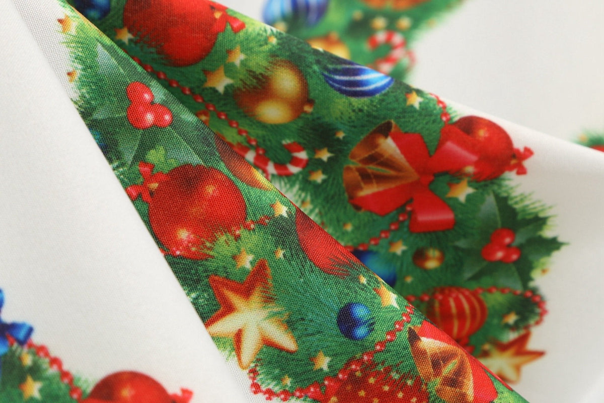 Women's Christmas swing dress with black bodice, bow belt and festive print
