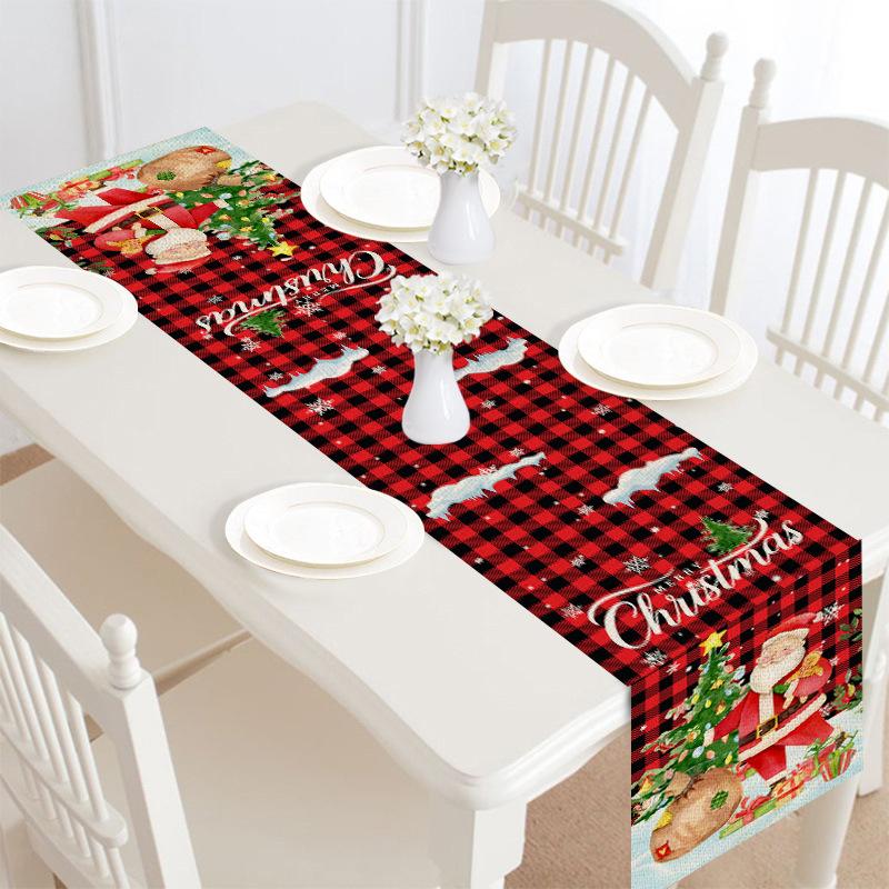 Christmas table runner, 30 x 180 cm, with a festive print on a laid table - red check with father christmas