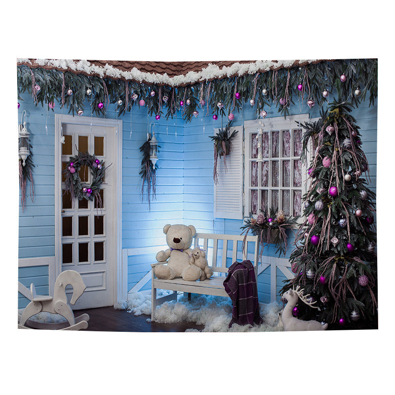 Christmas wall tapestry with a festive scene hanging on the wall - porch with teddy bear