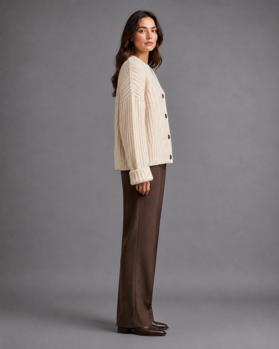 Women's chunky cable knit cardigan with a V-neck and dark buttons