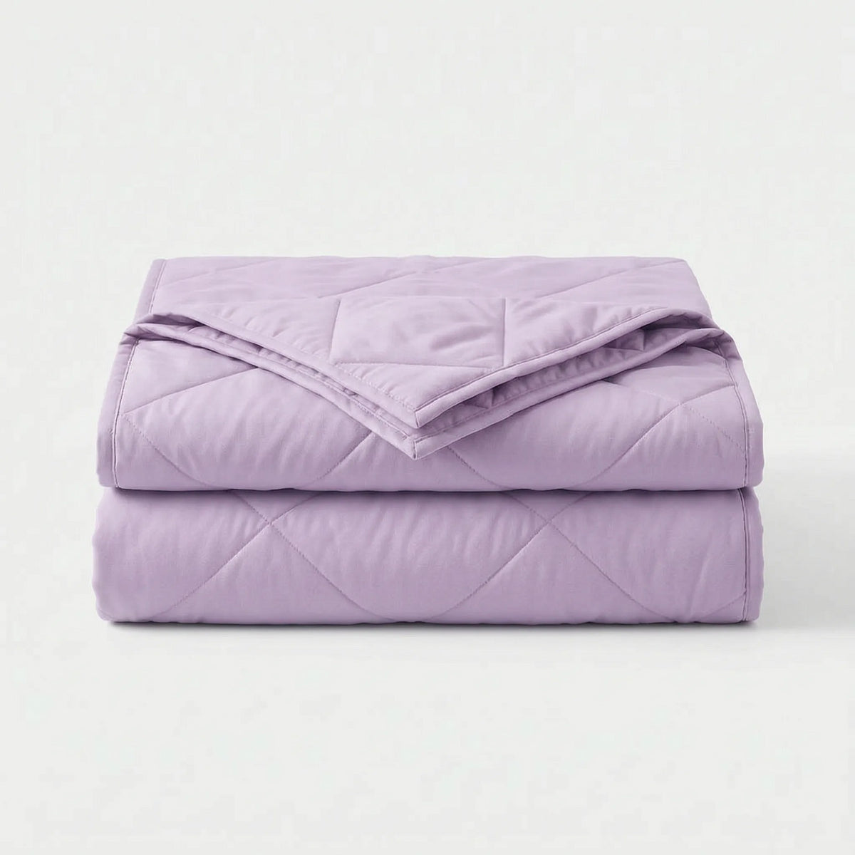 Light cooling blanket with diamond stitching over a made bed - lilac