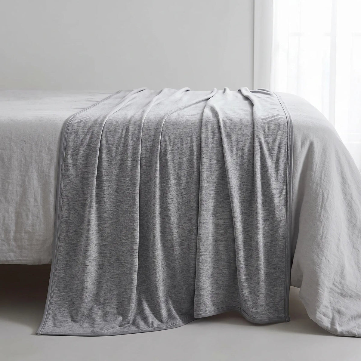 Reversible cooling blanket over a made bed