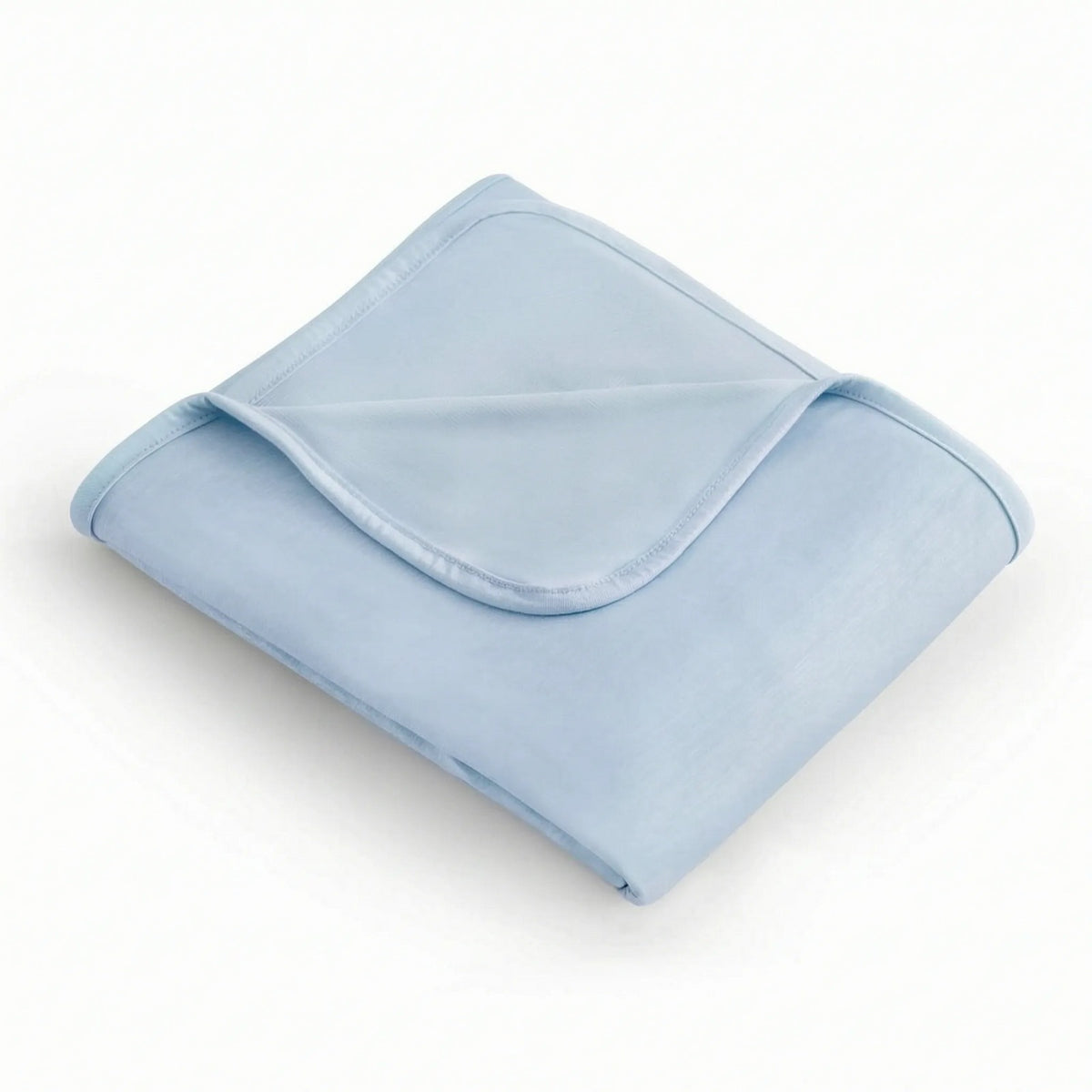 Reversible cooling blanket over a made bed - light blue