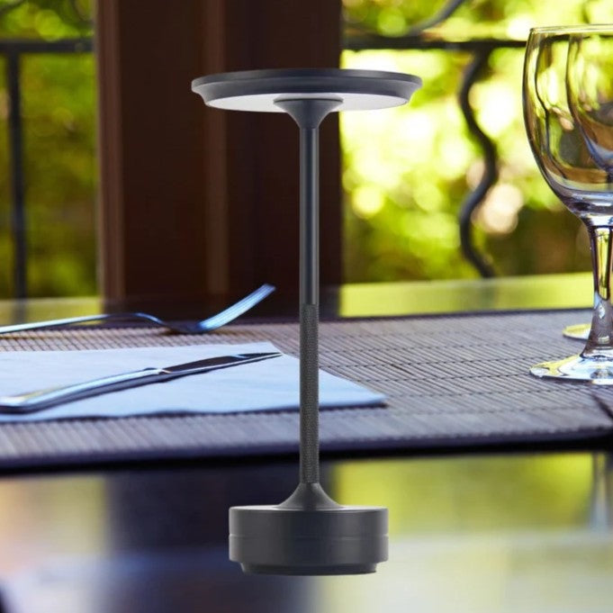 Cordless aluminium table lamp with a flat round shade, slim stem and round base - black