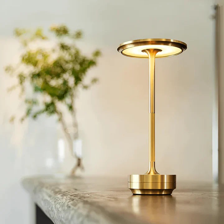 Cordless aluminium table lamp with a flat round shade, slim stem and round base