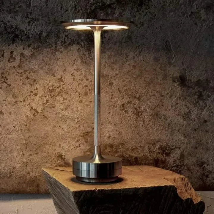 Cordless aluminium table lamp with a flat round shade, slim stem and round base