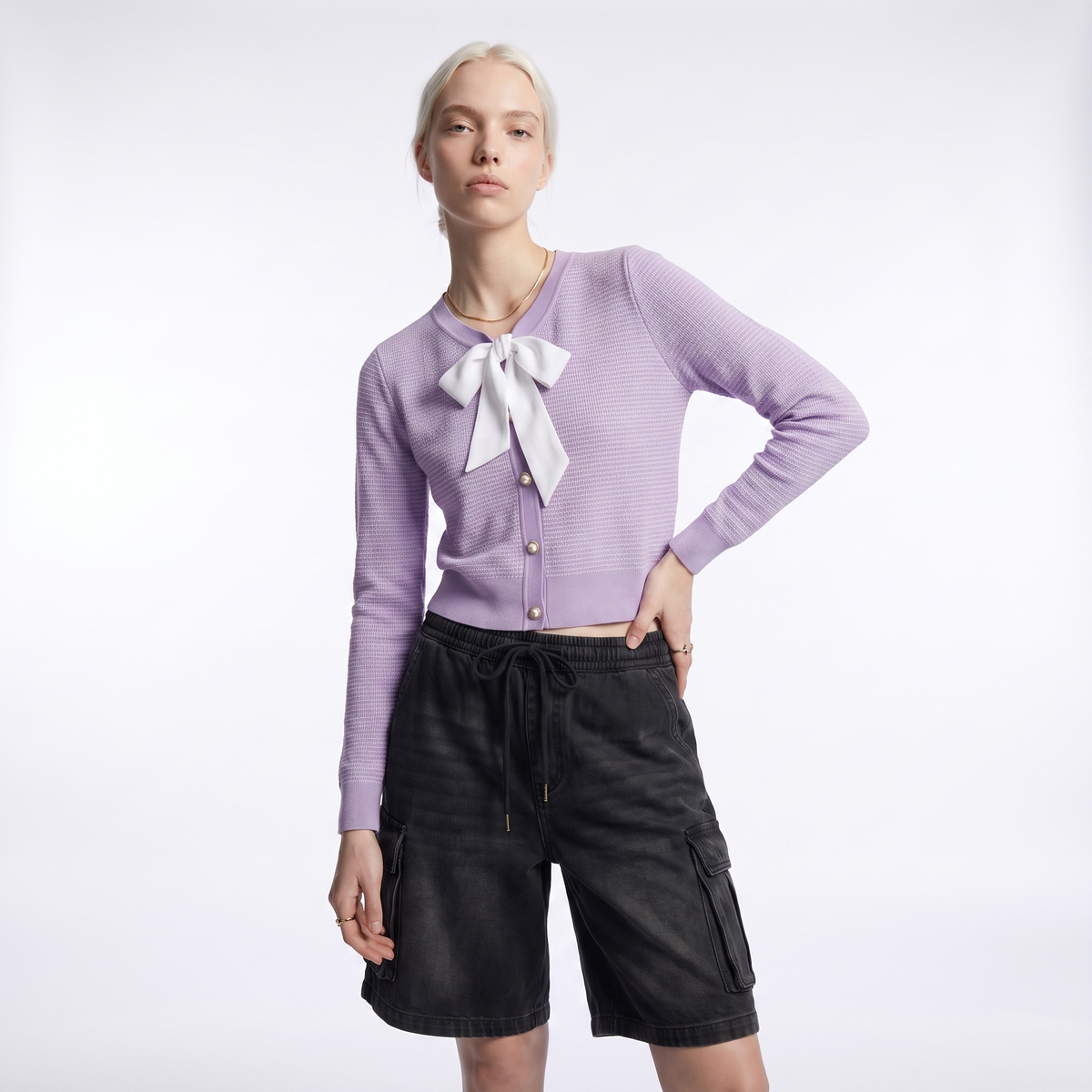 Women's cropped cardigan with a white bow at the V-neck and pearl-look buttons