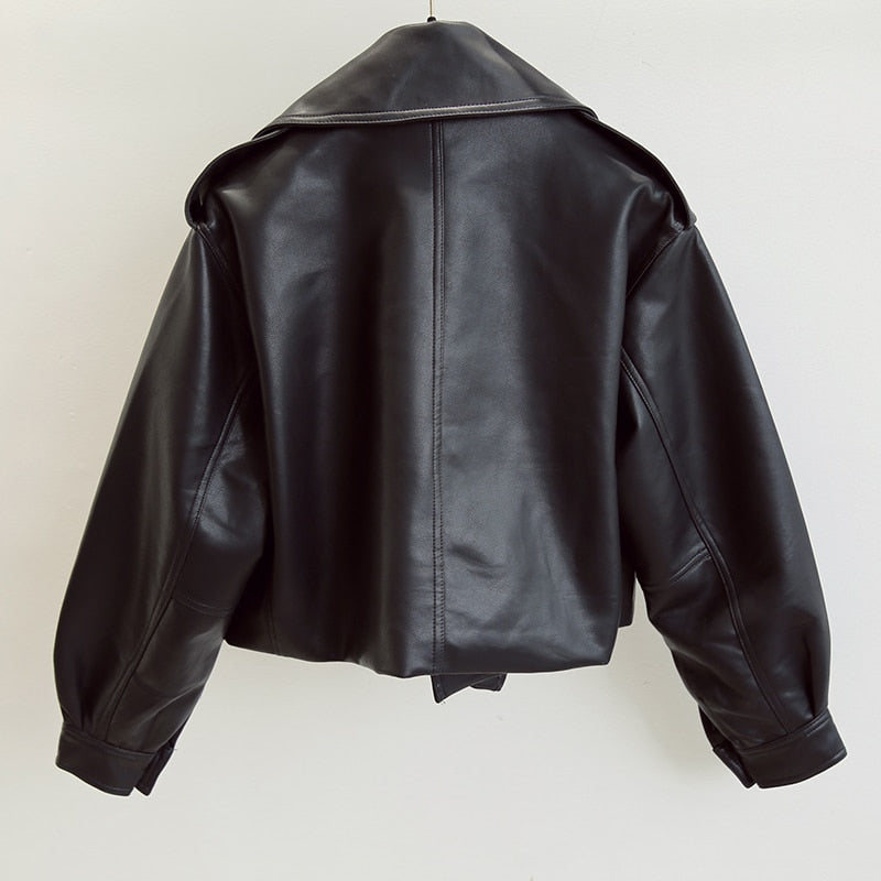 Women's cropped faux leather biker jacket with a wide collar and buckle